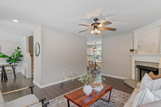 404 Ascott Way, Durham, NC 27713 - living room featuring ceiling fan, dark wood-style floors, a fireplace, a textured ceiling, and recessed lighting