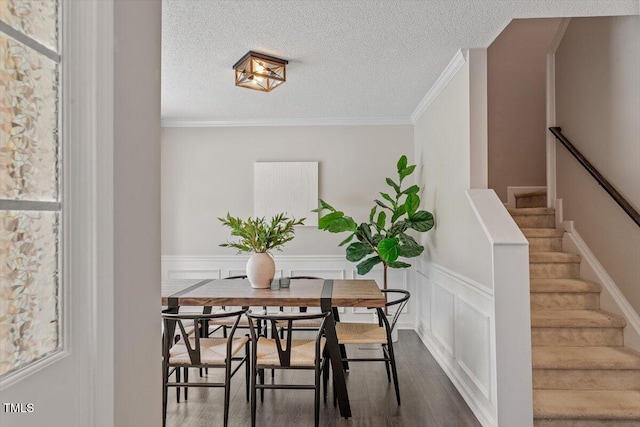 404 Ascott Way, Durham, NC 27713 - dining area with dark wood finished floors, a textured ceiling, wainscoting, plenty of natural light, and stairway