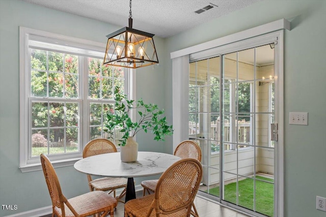 404 Ascott Way, Durham, NC 27713 - dining space with a chandelier and a textured ceiling