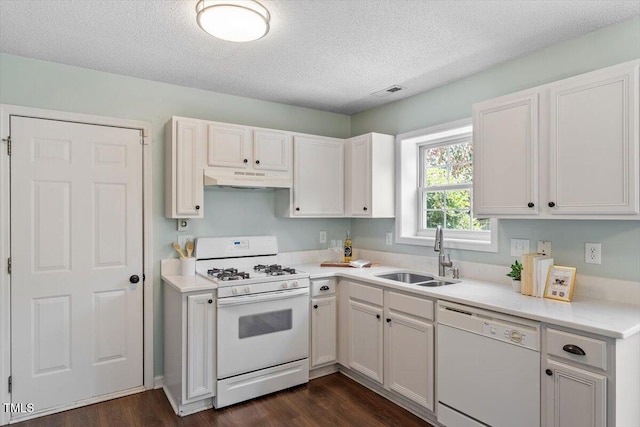 404 Ascott Way, Durham, NC 27713 - kitchen with white appliances, under cabinet range hood, a textured ceiling, dark wood-style flooring, and light countertops