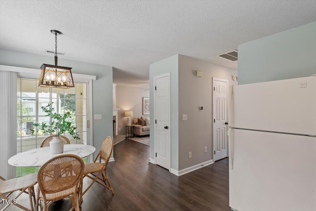 404 Ascott Way, Durham, NC 27713 - dining room featuring dark wood-type flooring, a chandelier, and a textured ceiling