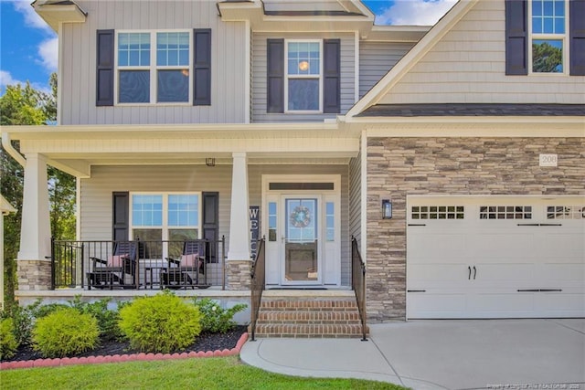 208 Walker Downs Cir, Fayetteville, NC 28305 - view of exterior entry with stone siding, a porch, and concrete driveway