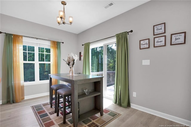 208 Walker Downs Cir, Fayetteville, NC 28305 - dining space featuring a chandelier and light wood-style flooring
