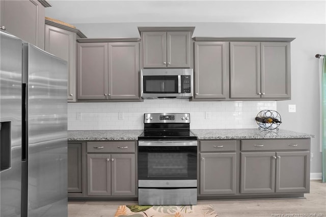 208 Walker Downs Cir, Fayetteville, NC 28305 - kitchen featuring stainless steel appliances, gray cabinets, and decorative backsplash
