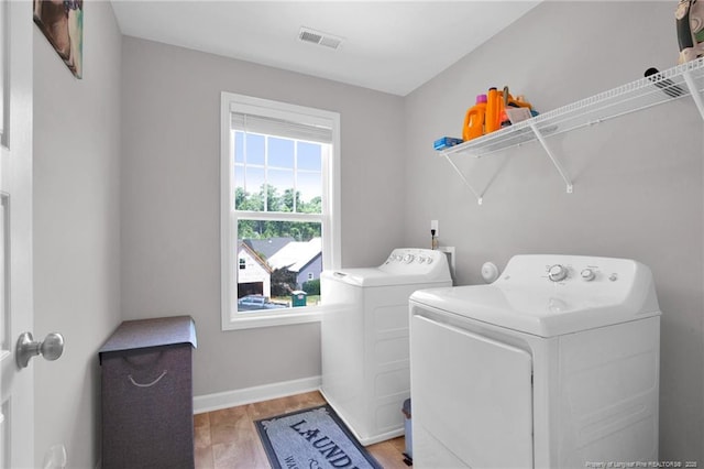 208 Walker Downs Cir, Fayetteville, NC 28305 - washroom featuring separate washer and dryer and wood finished floors
