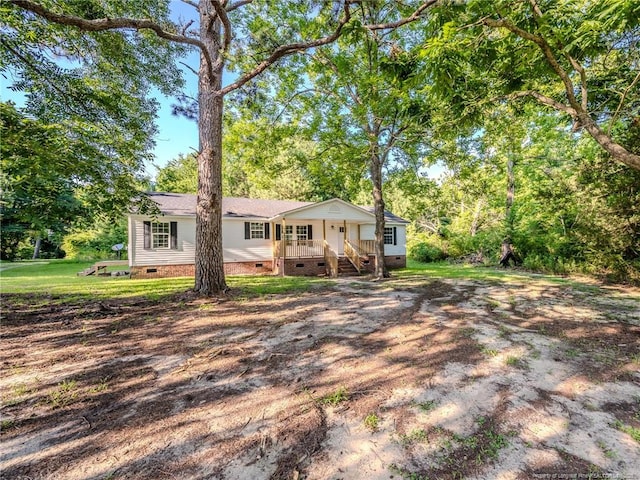 40 Ella Bell Rd, Clarkton, NC 28433 - view of front of house with crawl space, a porch, and view of wooded area