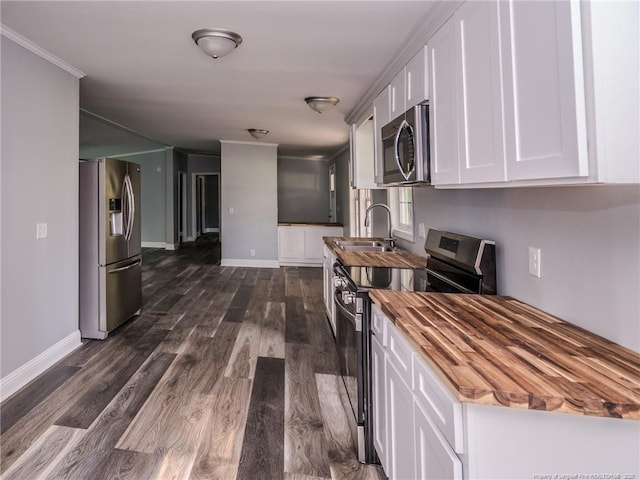 40 Ella Bell Rd, Clarkton, NC 28433 - kitchen with butcher block countertops, appliances with stainless steel finishes, white cabinets, and dark wood-style floors