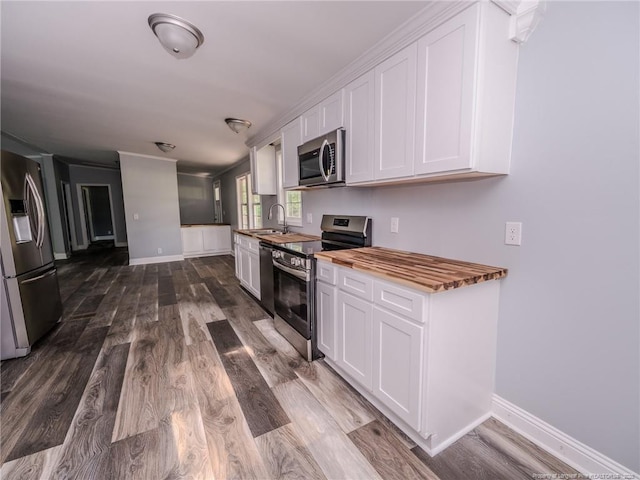 40 Ella Bell Rd, Clarkton, NC 28433 - kitchen featuring stainless steel appliances, white cabinetry, dark wood finished floors, and wooden counters