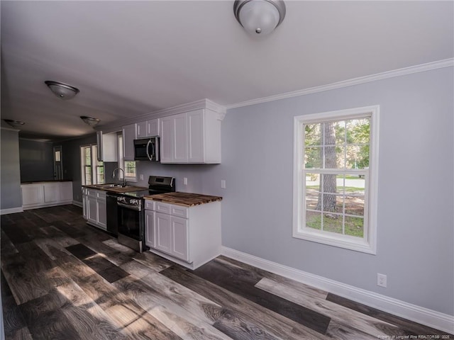 40 Ella Bell Rd, Clarkton, NC 28433 - kitchen with stainless steel appliances, dark countertops, ornamental molding, dark wood-style flooring, and white cabinetry