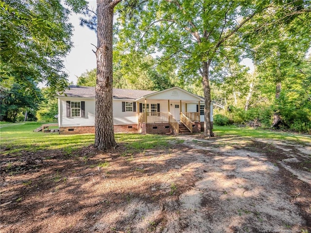 40 Ella Bell Rd, Clarkton, NC 28433 - view of front facade with crawl space, covered porch, and a front lawn
