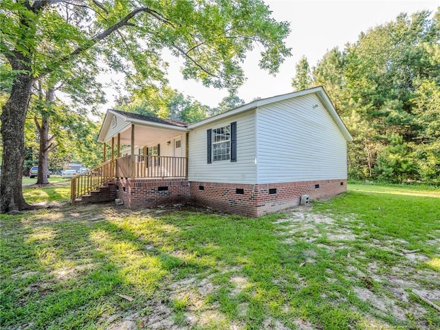 40 Ella Bell Rd, Clarkton, NC 28433 - view of property exterior with crawl space, a lawn, and covered porch