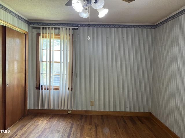 417 Sunnyview Rd, Henderson, NC 27536 - unfurnished room featuring ceiling fan, wood finished floors, a textured ceiling, and wallpapered walls