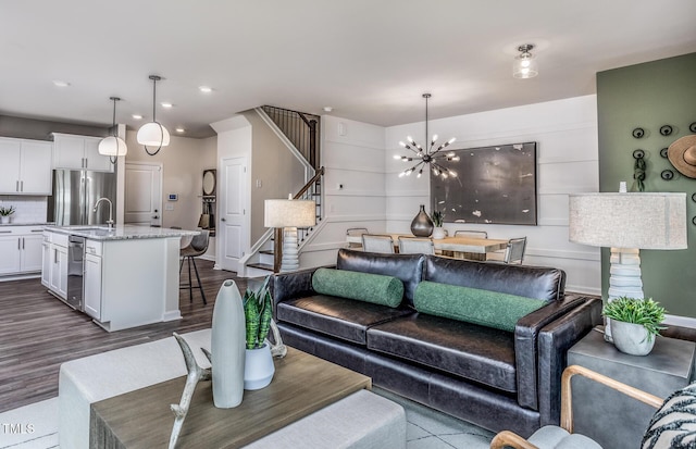288 Fosterton Cottage Way, Raleigh, NC 27603 - living room with stairs, a chandelier, dark wood-style flooring, and recessed lighting