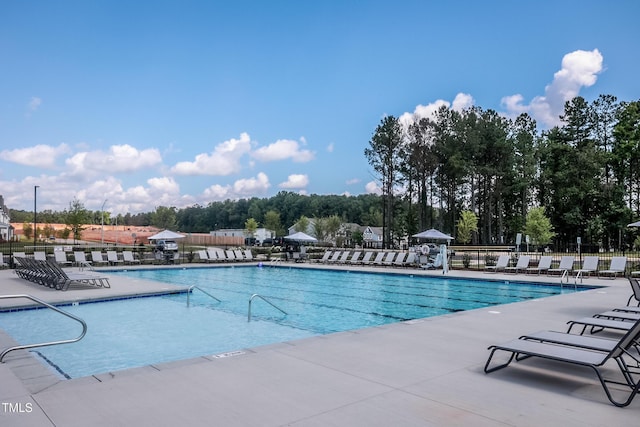 288 Fosterton Cottage Way, Raleigh, NC 27603 - community pool featuring a patio area and view of wooded area