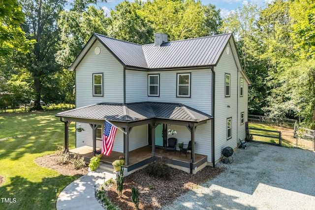 605 W Holt St, Mebane, NC 27302 - view of front of home featuring a metal roof, a chimney, a porch, and view of scattered trees