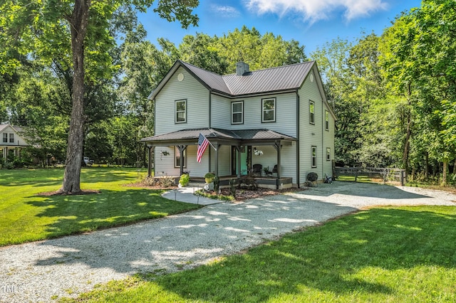 605 W Holt St, Mebane, NC 27302 - view of front of property with a chimney, a metal roof, covered porch, gravel driveway, and view of wooded area