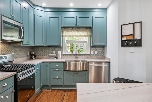 605 W Holt St, Mebane, NC 27302 - kitchen featuring appliances with stainless steel finishes, dark wood-style flooring, decorative backsplash, light stone counters, and recessed lighting