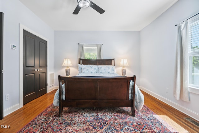 605 W Holt St, Mebane, NC 27302 - bedroom featuring multiple windows, wood finished floors, and ceiling fan