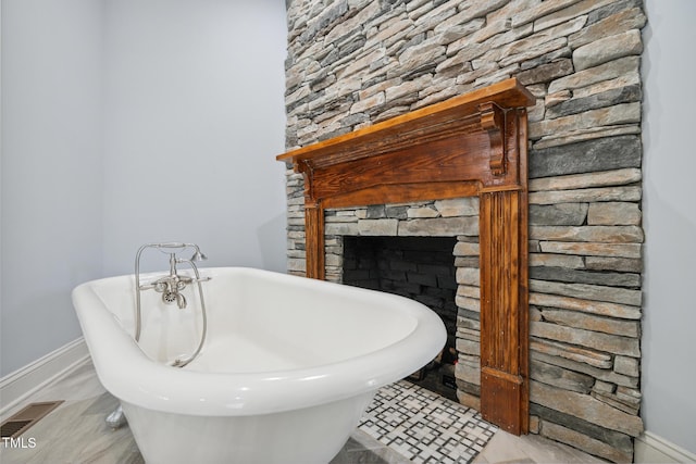 605 W Holt St, Mebane, NC 27302 - full bath featuring a freestanding bath and a stone fireplace