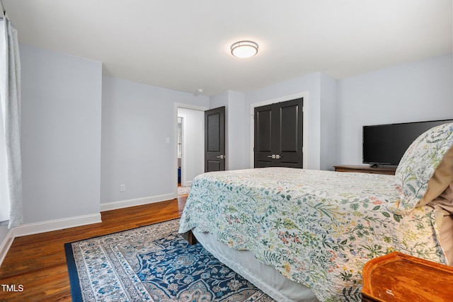 605 W Holt St, Mebane, NC 27302 - bedroom featuring baseboards and wood finished floors