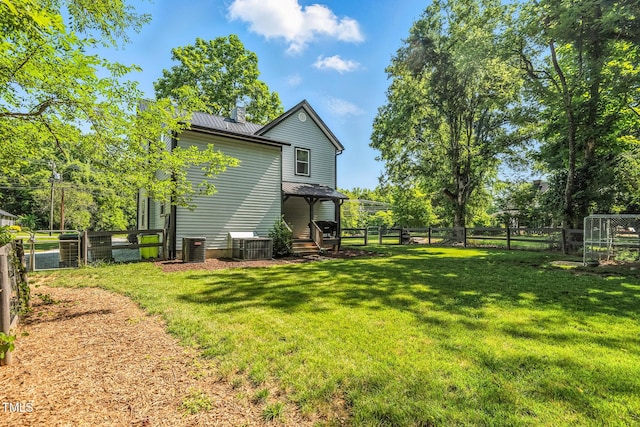 605 W Holt St, Mebane, NC 27302 - back of house featuring a fenced backyard and a metal roof