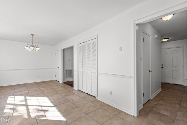 7 Hannah Ct, Durham, NC 27713 - empty room with light tile patterned floors and a chandelier
