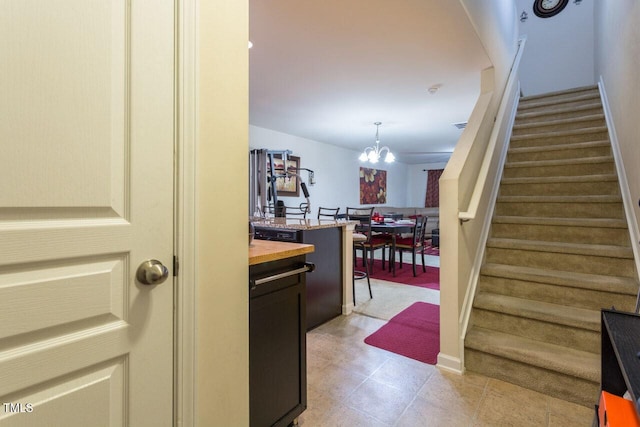 4009 Tresco Xing, Raleigh, NC 27616 - stairs featuring a chandelier and baseboards