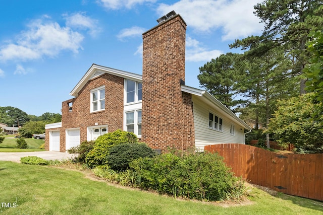 6608 Quiet Cove Ct, Raleigh, NC 27612 - view of side of home featuring a chimney, driveway, brick siding, and a garage