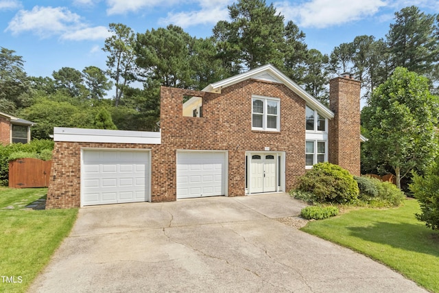6608 Quiet Cove Ct, Raleigh, NC 27612 - traditional home featuring concrete driveway, a chimney, brick siding, and a front yard