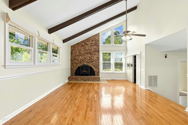 6608 Quiet Cove Ct, Raleigh, NC 27612 - unfurnished living room with a fireplace, a ceiling fan, beam ceiling, light wood-type flooring, and high vaulted ceiling