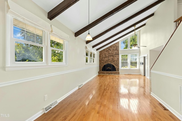 6608 Quiet Cove Ct, Raleigh, NC 27612 - unfurnished living room with beamed ceiling, ceiling fan, light wood-style floors, high vaulted ceiling, and a fireplace