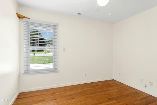 6608 Quiet Cove Ct, Raleigh, NC 27612 - empty room featuring light wood finished floors, healthy amount of natural light, and a ceiling fan
