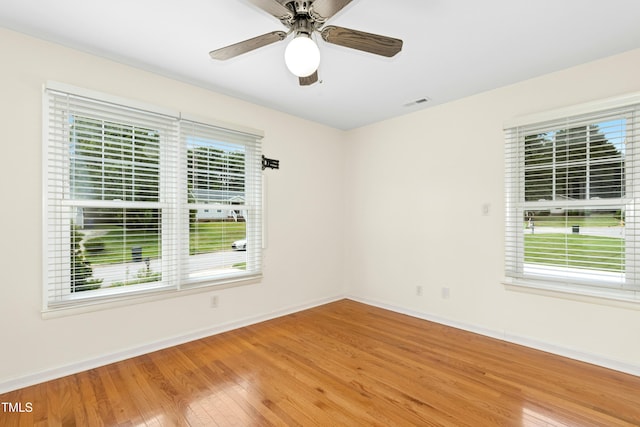 6608 Quiet Cove Ct, Raleigh, NC 27612 - spare room with wood finished floors, healthy amount of natural light, and a ceiling fan