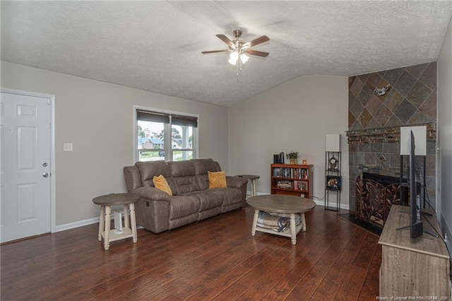 5411 Archer Rd, Hope Mills, NC 28348 - living area featuring lofted ceiling, ceiling fan, dark wood-type flooring, a textured ceiling, and a fireplace