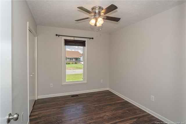 5411 Archer Rd, Hope Mills, NC 28348 - spare room featuring a textured ceiling, dark wood-style flooring, and ceiling fan