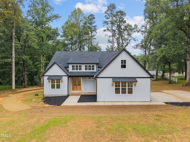 5027 Preacher Holmes Rd, Graham, NC 27253 - modern farmhouse with a shingled roof, a front lawn, and french doors