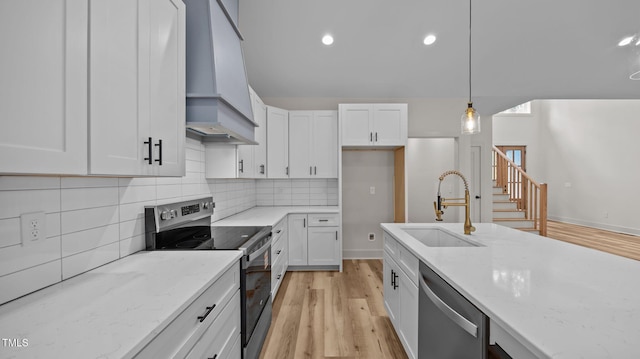 5027 Preacher Holmes Rd, Graham, NC 27253 - kitchen with appliances with stainless steel finishes, white cabinets, decorative backsplash, light wood-type flooring, and recessed lighting
