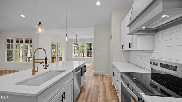 5027 Preacher Holmes Rd, Graham, NC 27253 - kitchen with appliances with stainless steel finishes, extractor fan, light wood-style floors, recessed lighting, and decorative backsplash