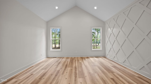 5027 Preacher Holmes Rd, Graham, NC 27253 - empty room featuring healthy amount of natural light, light wood-style flooring, vaulted ceiling, and recessed lighting