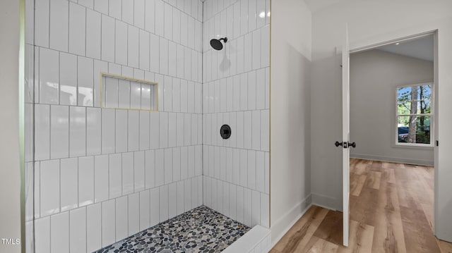 5027 Preacher Holmes Rd, Graham, NC 27253 - bathroom with a tile shower, wood finished floors, and lofted ceiling