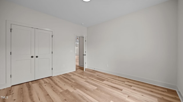 5027 Preacher Holmes Rd, Graham, NC 27253 - unfurnished bedroom with light wood finished floors and a closet