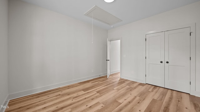 5027 Preacher Holmes Rd, Graham, NC 27253 - unfurnished bedroom featuring attic access, light wood-type flooring, and a closet