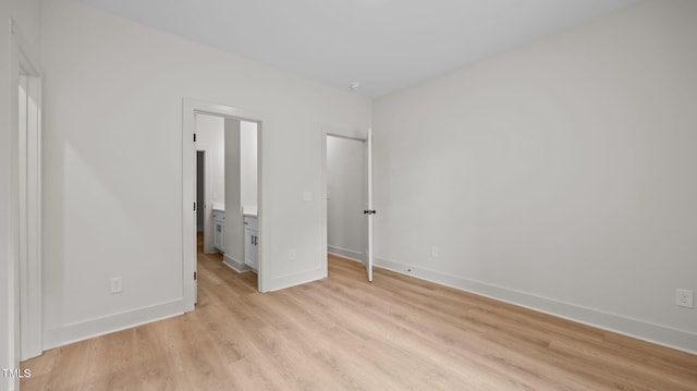 5027 Preacher Holmes Rd, Graham, NC 27253 - unfurnished bedroom with light wood-type flooring, ensuite bathroom, and a spacious closet