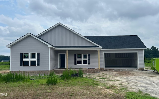 108 Lynn Ln, Selma, NC 27576 - view of front of property with covered porch, a garage, driveway, and roof with shingles