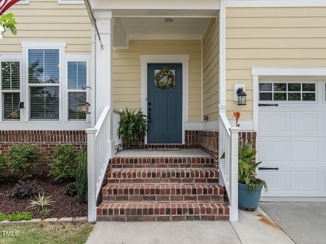 3441 Jordan Shires Dr, New Hill, NC 27562 - view of exterior entry with covered porch, concrete driveway, and a garage