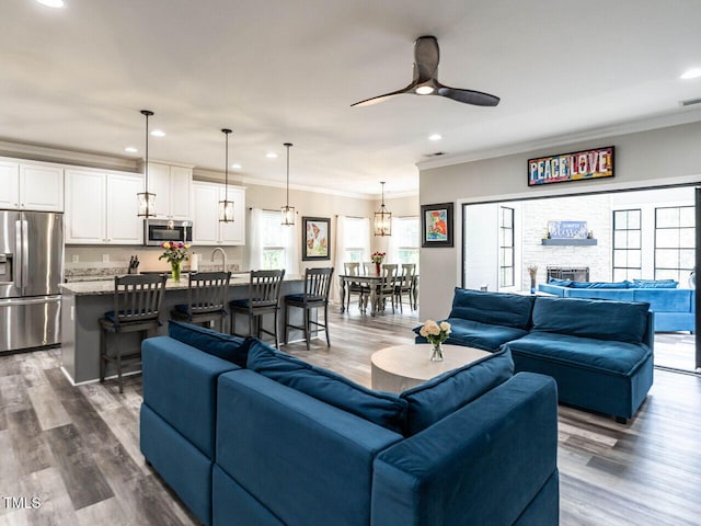 3441 Jordan Shires Dr, New Hill, NC 27562 - living area with crown molding, recessed lighting, dark wood-style floors, ceiling fan, and a stone fireplace