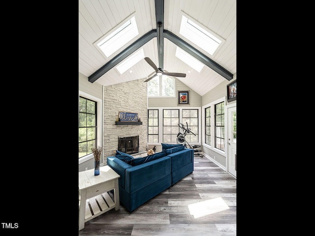 3441 Jordan Shires Dr, New Hill, NC 27562 - living room featuring a skylight, high vaulted ceiling, a fireplace, beamed ceiling, and a ceiling fan