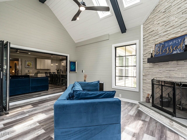 3441 Jordan Shires Dr, New Hill, NC 27562 - living room featuring a skylight, high vaulted ceiling, ceiling fan, wood finished floors, and beamed ceiling
