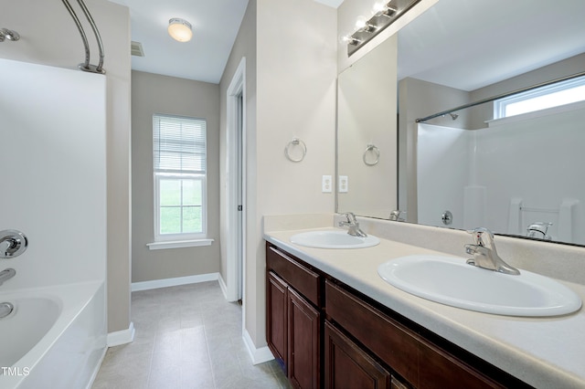 103 Bermuda Green Dr, Durham, NC 27703 - bathroom featuring healthy amount of natural light, double vanity, tile patterned floors, and  shower combination