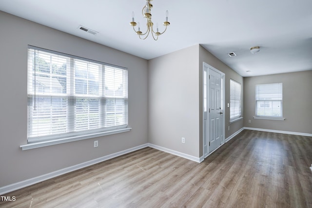 103 Bermuda Green Dr, Durham, NC 27703 - empty room with wood finished floors and a chandelier